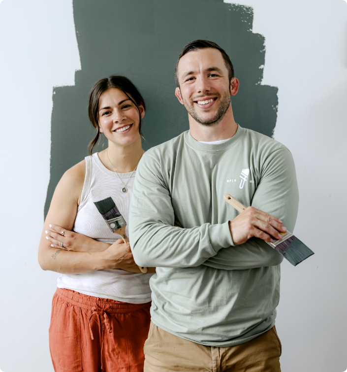 residential painting twin cities - woman and man holding paint brushes