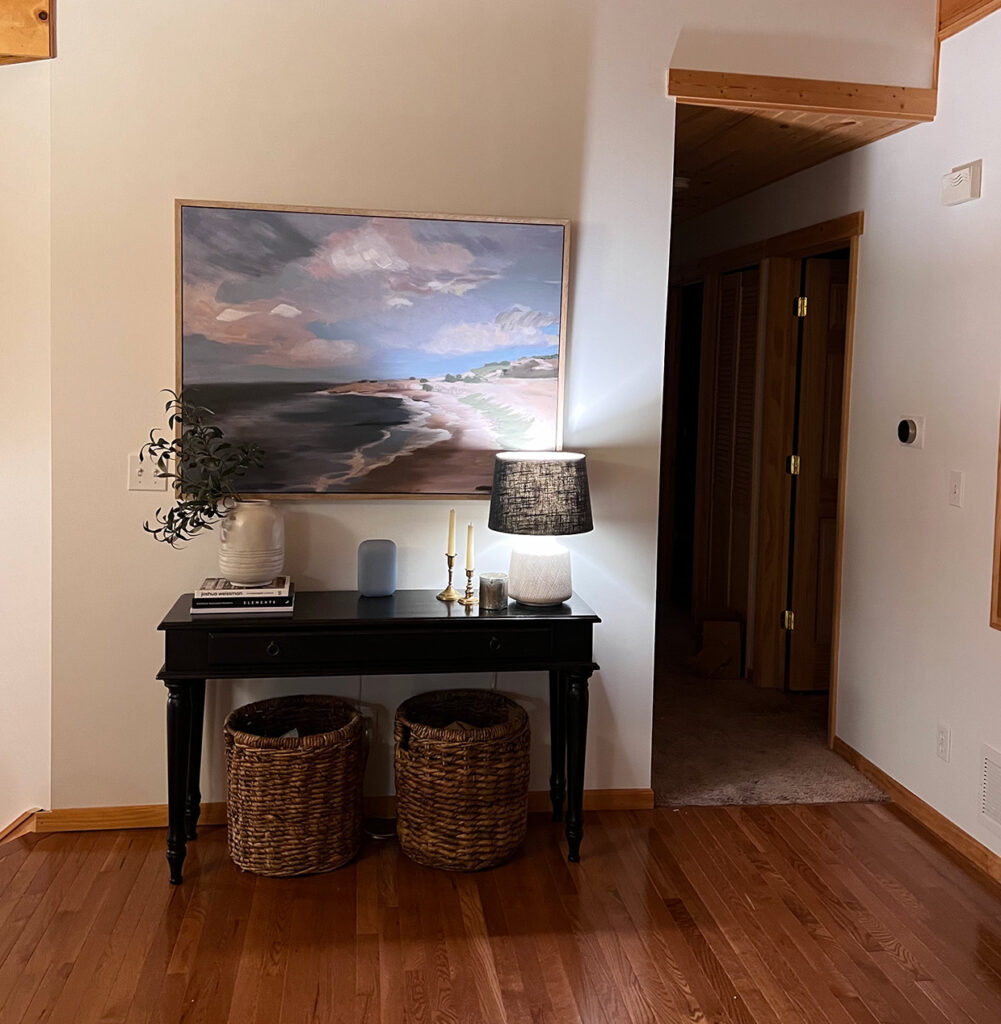 entryway with table and picture