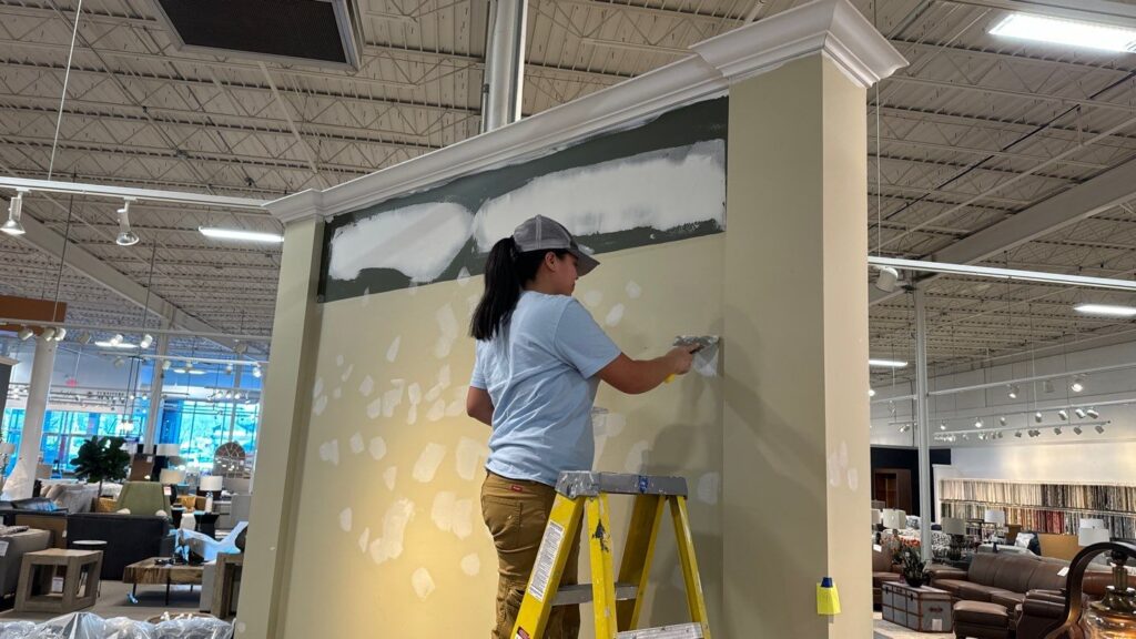 Painter prepping commercial space for painting