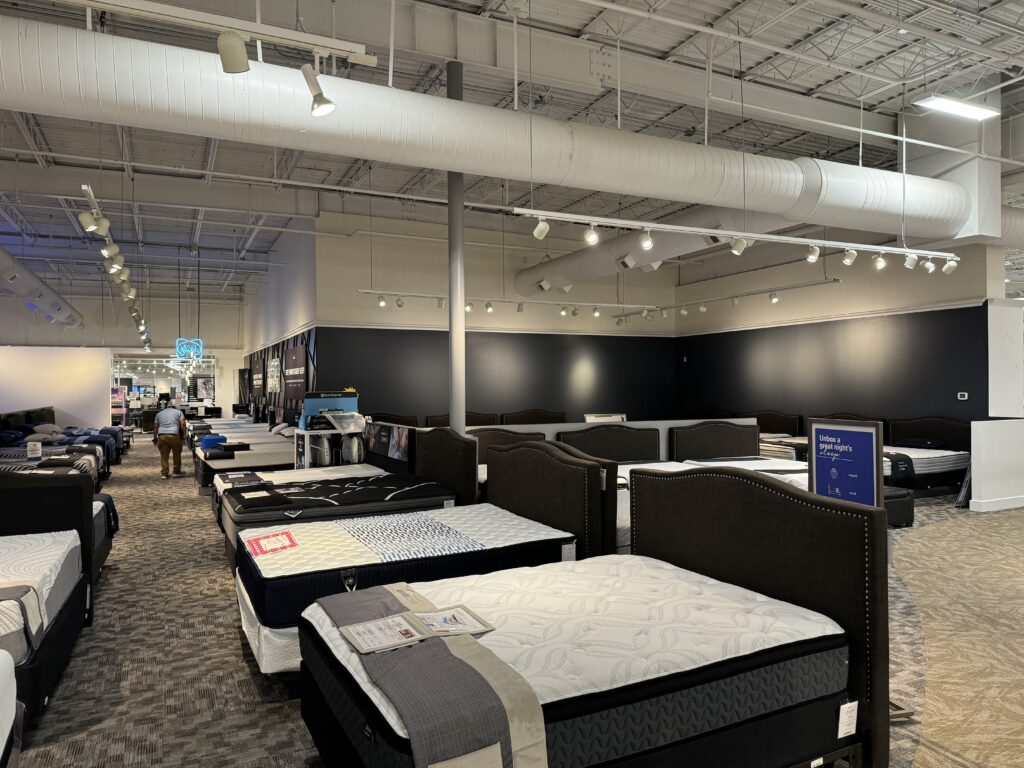 rows of mattresses in furniture store