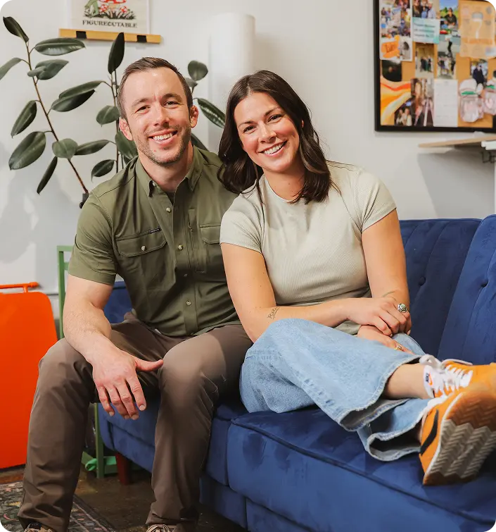 Danie and Ryan Turry sitting on a couch in an office